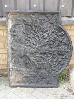 Lot 753 - A heavy floral decorated cast iron fire back,...