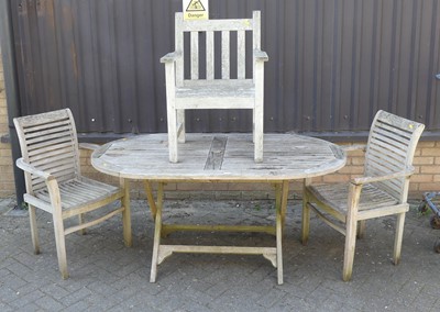 Lot 757 - A contemporary slatted teak patio table,...