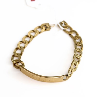 Lot 194 - A modern 9ct gold textured curb link identity...