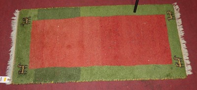 Lot 734 - A hand-woven Swedish rug with tasselled ends,...