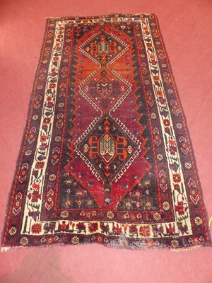 Lot 736 - A Persian woollen red, black and cream ground...