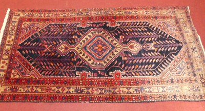 Lot 737 - A Persian woollen blue, red and cream ground...