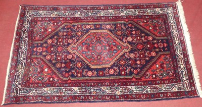 Lot 740 - A Persian woollen red, blue and cream ground...